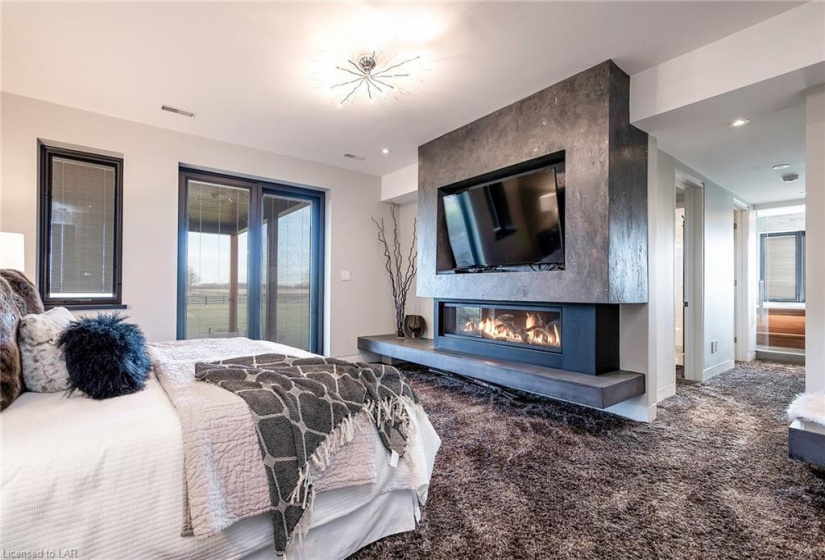Fantastic master bedroom suite that is in a wing of the home all on its own.  Contemporary gas fireplace which is a feature of the room all on its own.