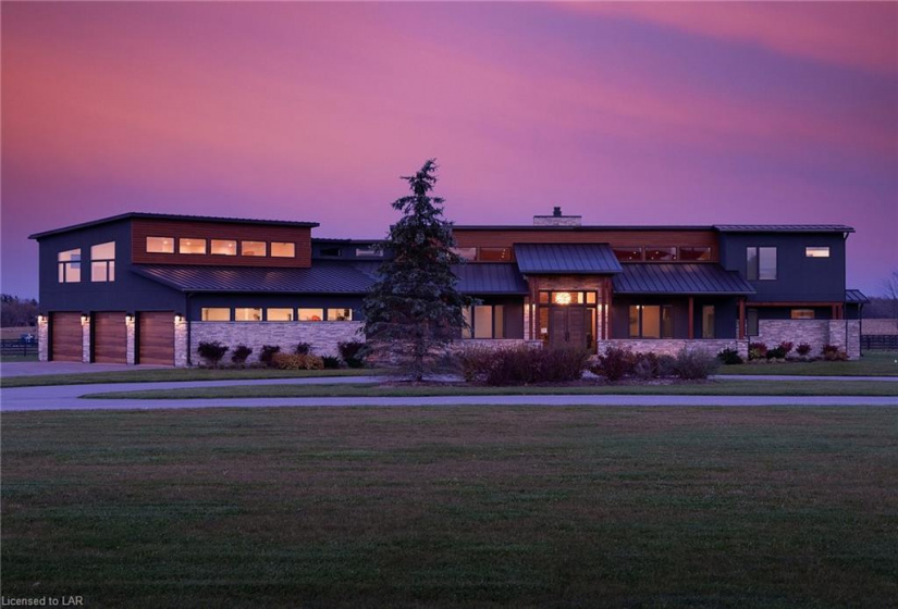 Sunset shots to the west of this incredible custom home. Stunning architecture with a timeless contemporary design.  Ashphalt driveway throughout the property to all out buildings.