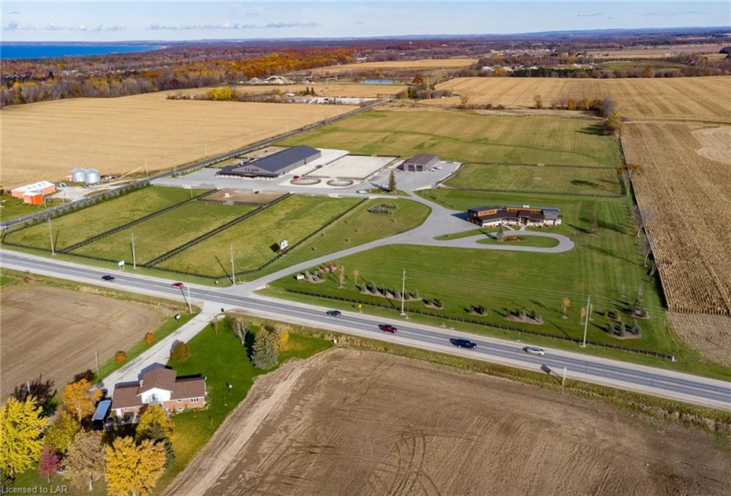 The aerial view of the complete property sprawling over 45 acres.  Includimg custom home, large oversized shop, world class equestrian facility and acreage for farming or hay.