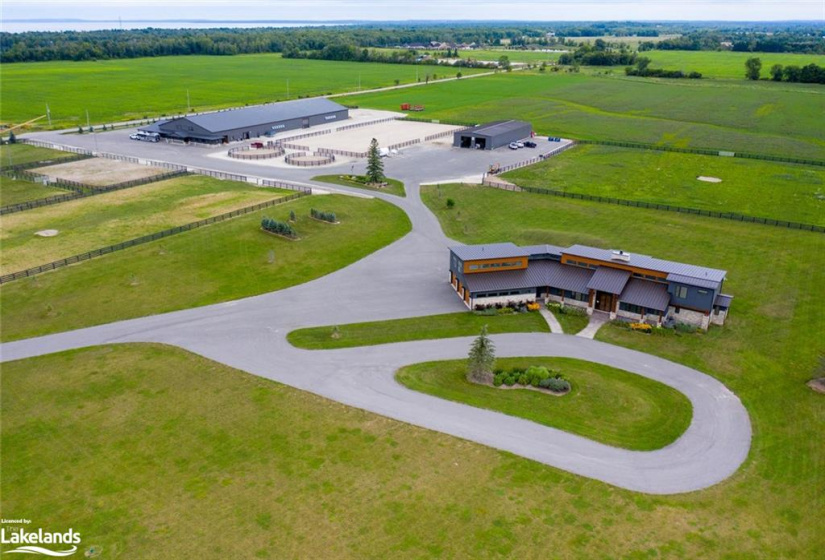 AERIAL VIEW OF HOUSE, BARN & RIDING ARENA, AND WORK SHOP ALL ON 45 ACRES